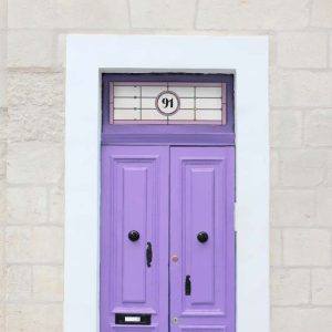 Stained glass door number with colourful circles and a central number