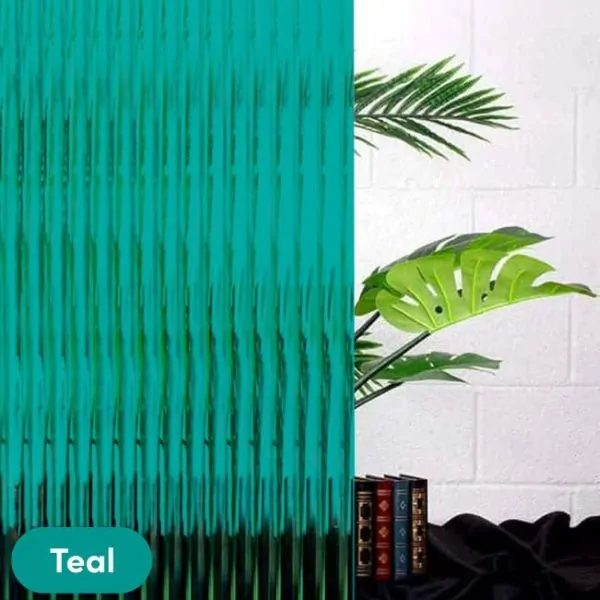Teal coloured reeded glass window film placed over glass with house plants in the background