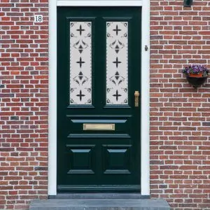 A Victorian frosted door window film with a traditional pattern that repeats