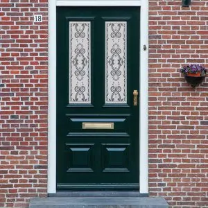 A Victorian frosted glass window film design with a flower pattern on a front door