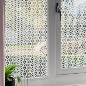flower patterned frosted window film design installed onto a front room window for home privacy.