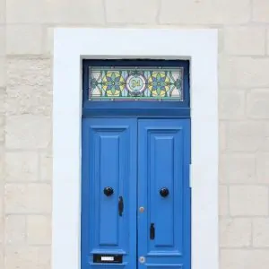 Harry flower stained glass window film with a central door number installed above a blue front door